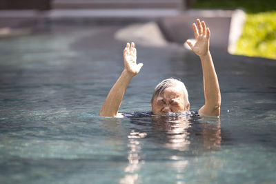 Portrait of woman swimming in pool