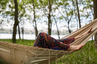 Low angle view of woman standing in forest