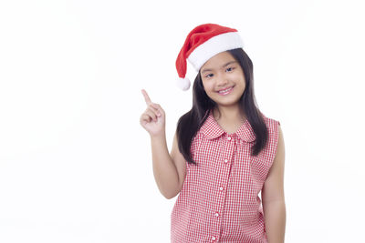 Portrait of a smiling young woman against white background