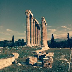 Old ruins in city against sky