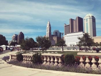 Buildings in city against cloudy sky