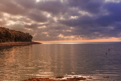 Stormy sky and reflections on the placid sea