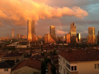 Skyscrapers against cloudy sky