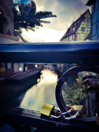 Close-up of bicycle on bridge against sky