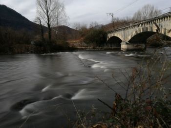 Bridge over river against sky