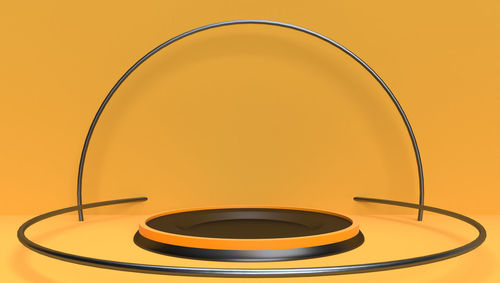 Close-up of electric lamp against orange background