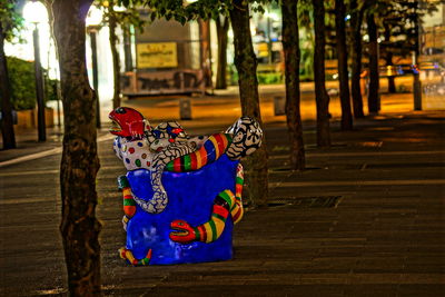 Graffiti on tree trunk in park