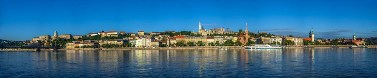 Panoramic view of the danube river and the embankment of buda on a sunny summer morning