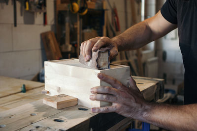 Carpenter grinding wooden box