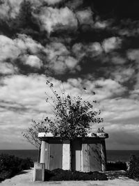 Built structure by sea against sky
