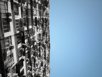 Low angle view of modern building against clear blue sky