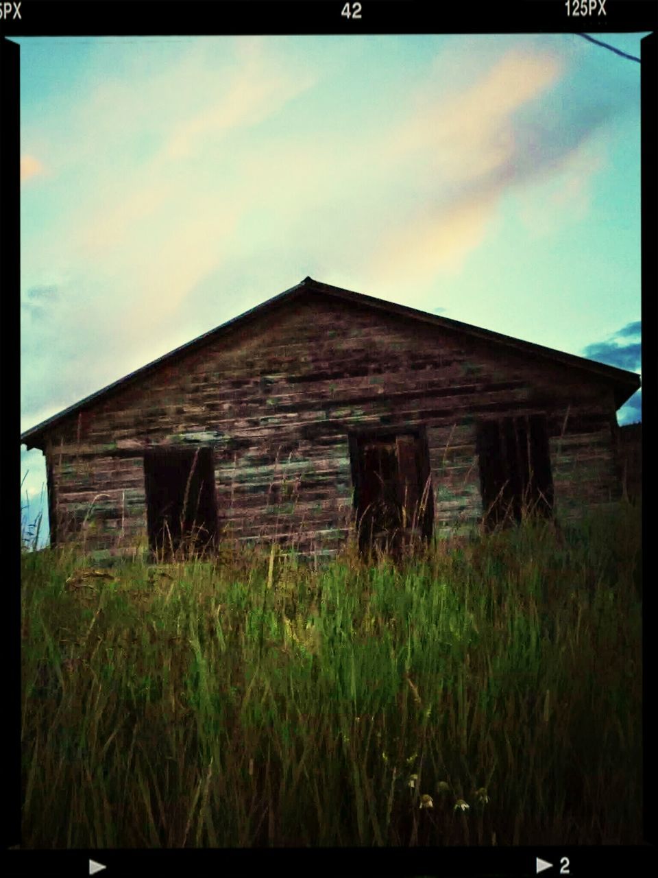 OLD HOUSE ON GRASSY FIELD