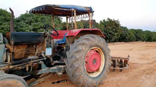 Abandoned tractor on field against sky