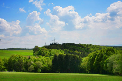 Scenic view of field against cloudy sky