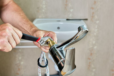 Close-up of man washing hands