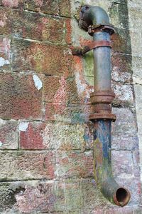 Rusty metal against wall