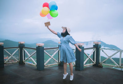 Full length of a man holding balloons