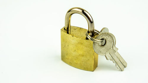 Close-up of padlock against white background