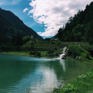 Scenic view of lake and mountains against sky