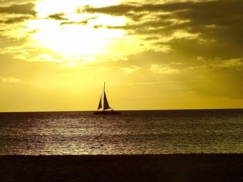 Silhouette sailboat on sea against sky during sunset