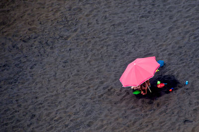 High angle view of pink umbrella at beach