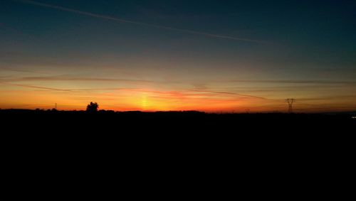 Silhouette landscape against sky during sunset