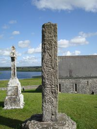 Stone structure in cemetery against sky