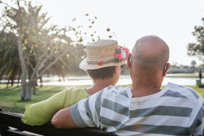 Couple of pensioners seen from behind sitting