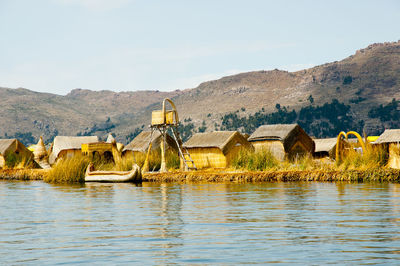 Panoramic view of lake and buildings against sky