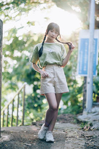 Full length of young woman exercising in park