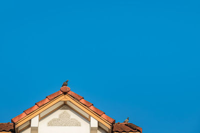 Low angle view of building against clear blue sky