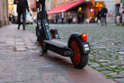 Two electric scooter parked on a footpath in the city center, modena, italy