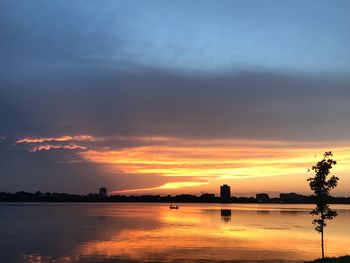 Scenic view of lake against orange sky