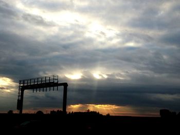 Silhouette built structure against sky during sunset