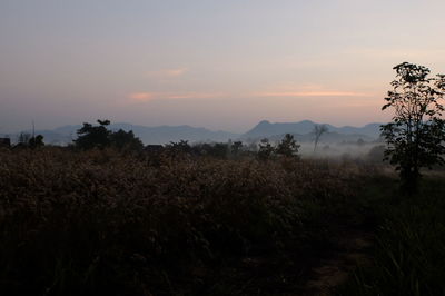 Scenic view of silhouette mountains against sky at sunset