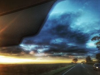 Road against dramatic sky during sunset