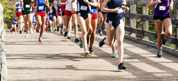 Low section of people running on road