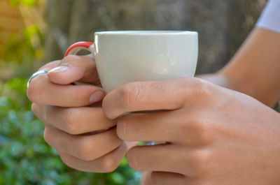 Close-up of woman holding coffee cup