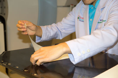 Midsection of woman working on table