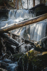 Water flowing through rocks with ice buildup in pennsylvania