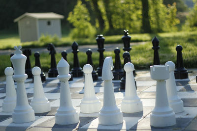 Chess pieces on board during sunny day