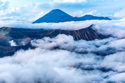 Scenic view of clouds over mountains against sky