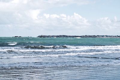 Scenic view of sea against cloudy sky