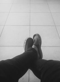 Low section of man sitting on tiled floor