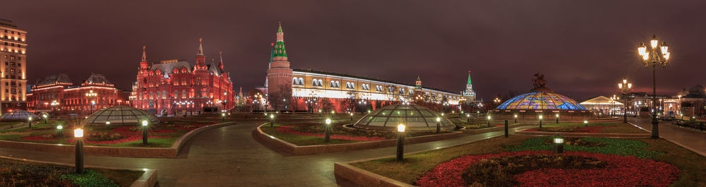 Panoramic view of illuminated buildings against sky at night