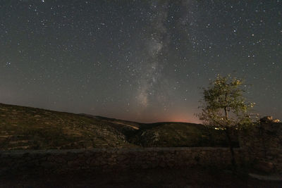 Scenic view of landscape against sky at night