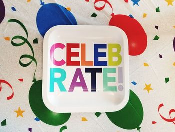 High angle view of colorful celebrate text on plate