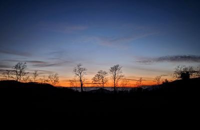 Silhouette landscape against sky during sunset