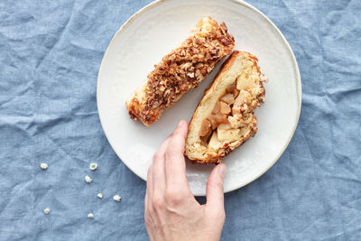 High angle view of person holding bread in plate