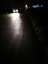 Illuminated street lights on road at night